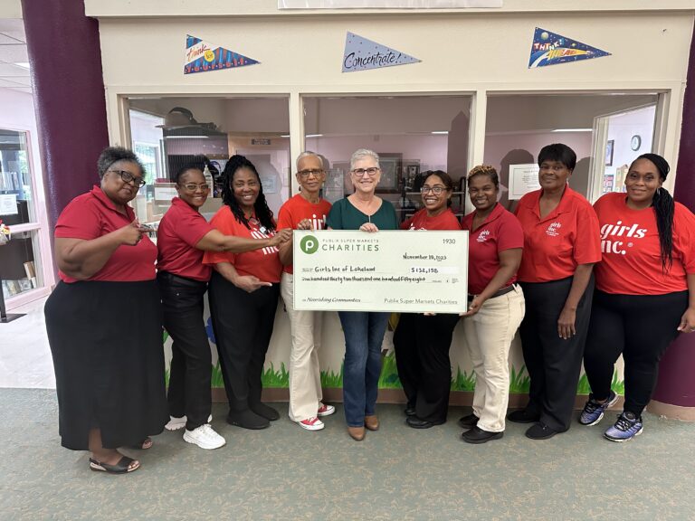 Staff members with a donor holding a check
